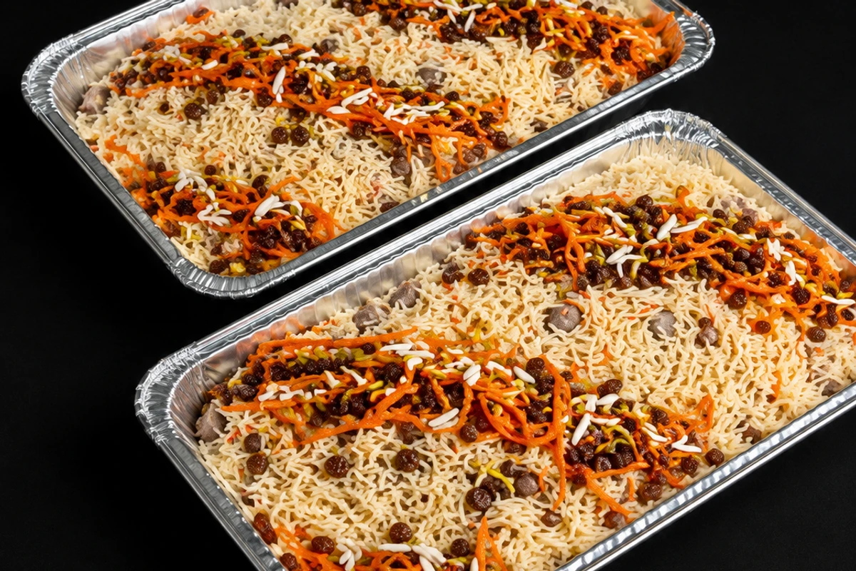 Kabuli pulao served without meat, the rice combed with caramelised carrot, raisins and slivered almond.